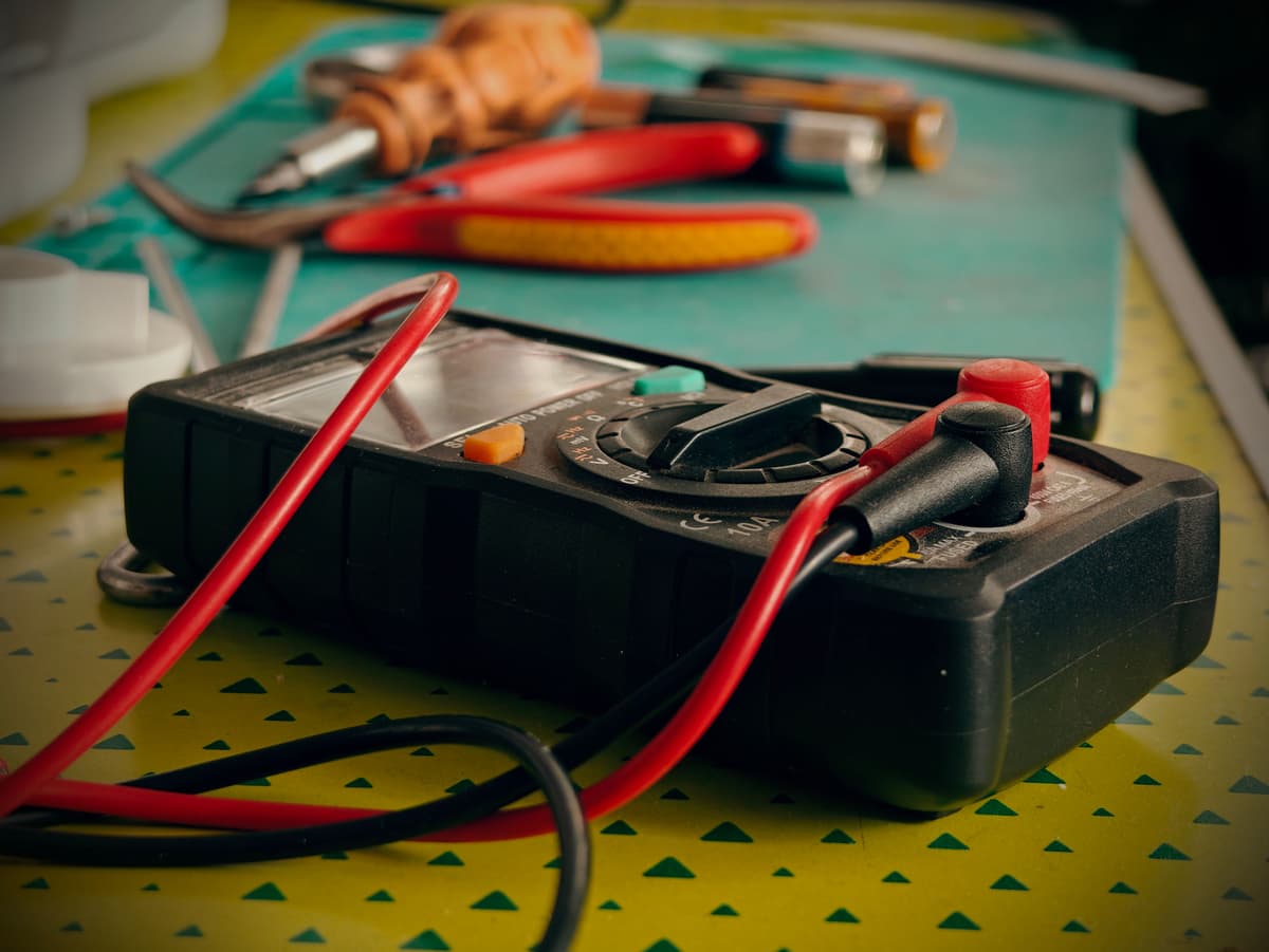 Multimeter and electrician tools on a workbench