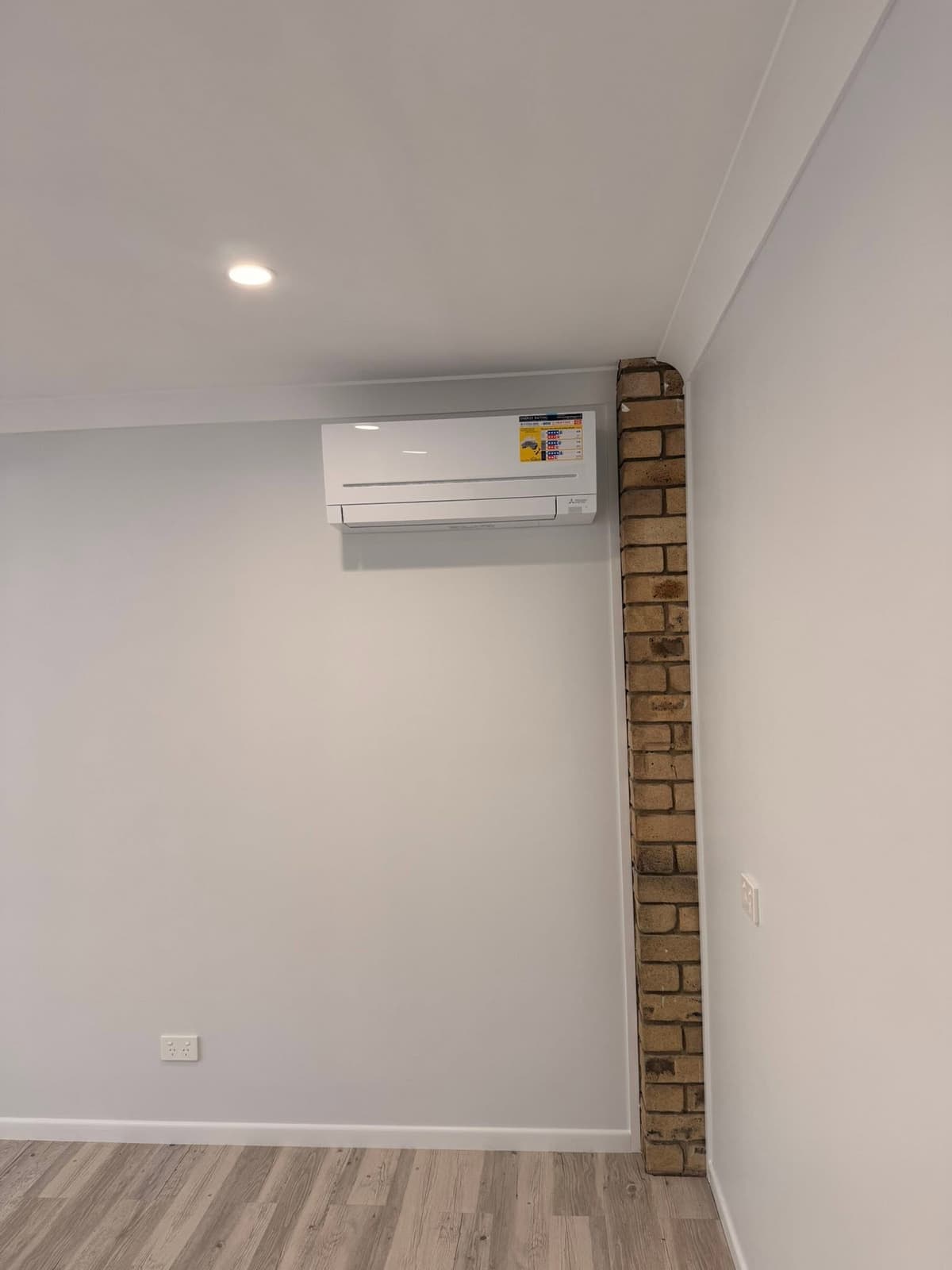 Renovated room with LED downlights and a split system, wired by Wattify Electrical